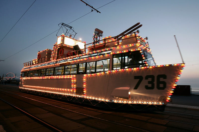 An illuminated tram car is seen on the sea front - the trams are lit up to represent boats, trains and much more.