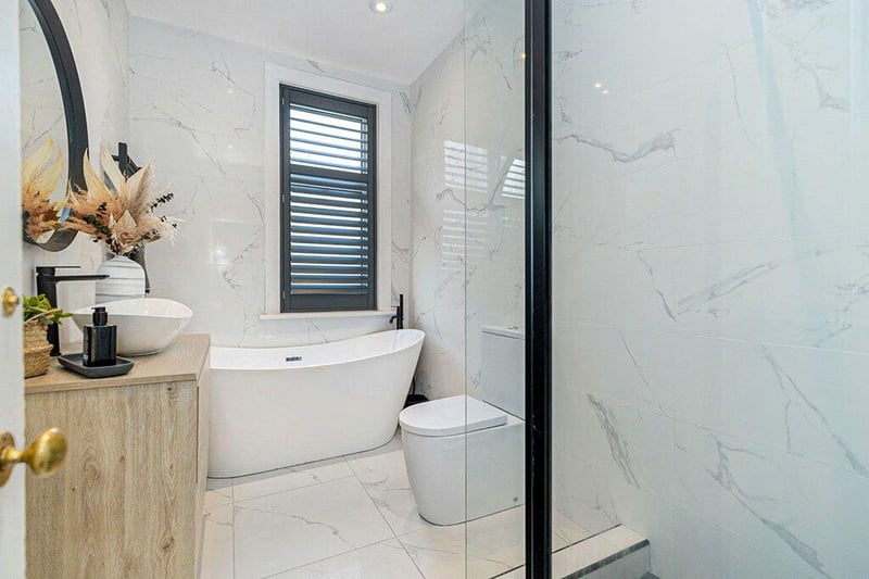 The re-fitted four-piece bathroom suite features a free standing bath and separate shower cubicle. 