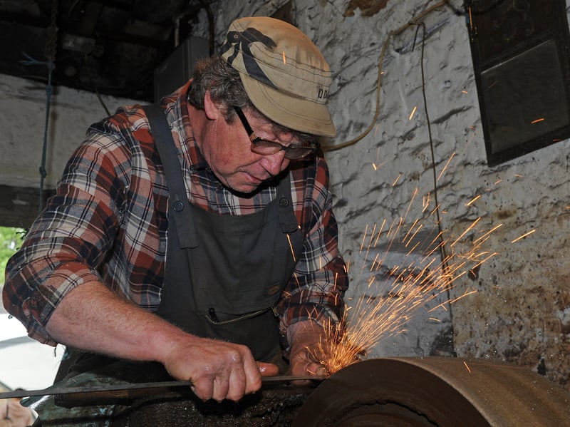 A craftsman is pictured grinding a blade at Abbeydale Industrial Hamlet, near Abbeydale Road, Sheffield. Both the buildings and the activities carried out there take visitors back to an earlier industrial age. Picture: Andrew Roe, National World