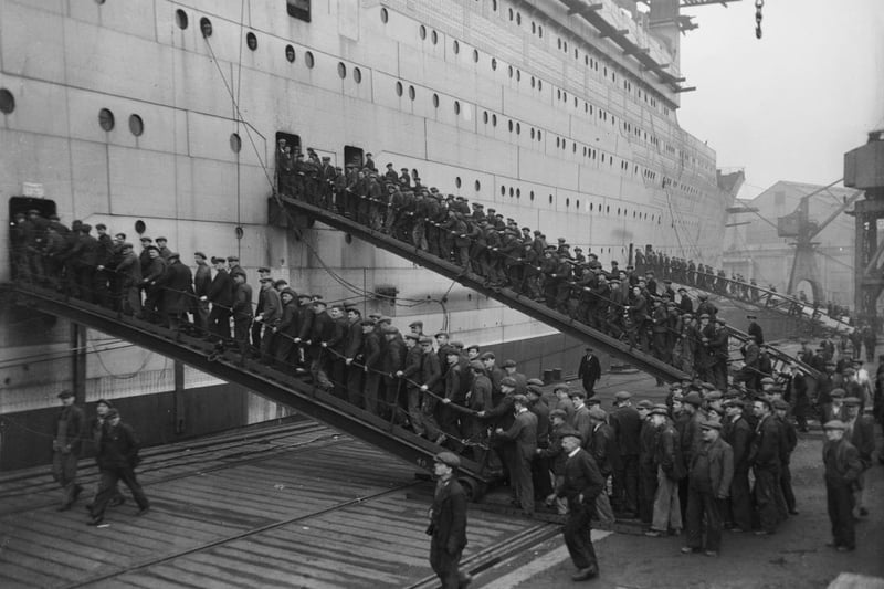Hundreds of Clyde workers return to the new liner Queen Mary during its fitting-out on Clydebank.