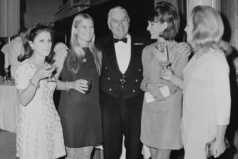 British sea officer John Treasure Jones (1905 - 1993), capitain of RMS Queen Mary, with passengers Michele Gagnon, Elizabeth Slattery, Countess of Brecknock and Sandra French, UK, 26th September 1967.