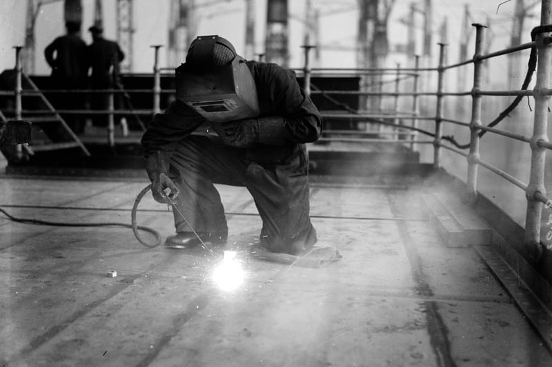 A welder at work on the construction of the liner Queen Mary at Clydebank. 
