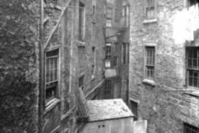 The back courts of two tenements wedge together tightly