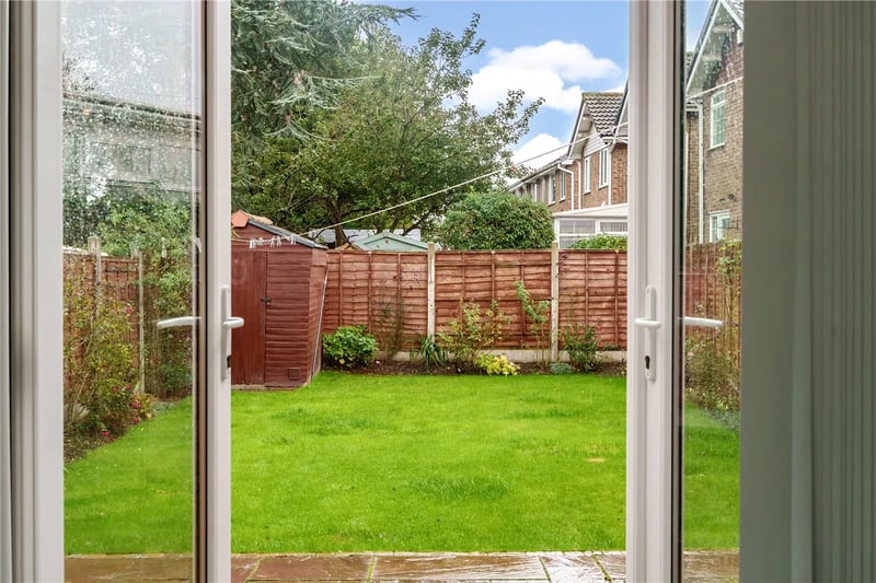 Glass doors in the kitchen lead to the enclosed rear garden.