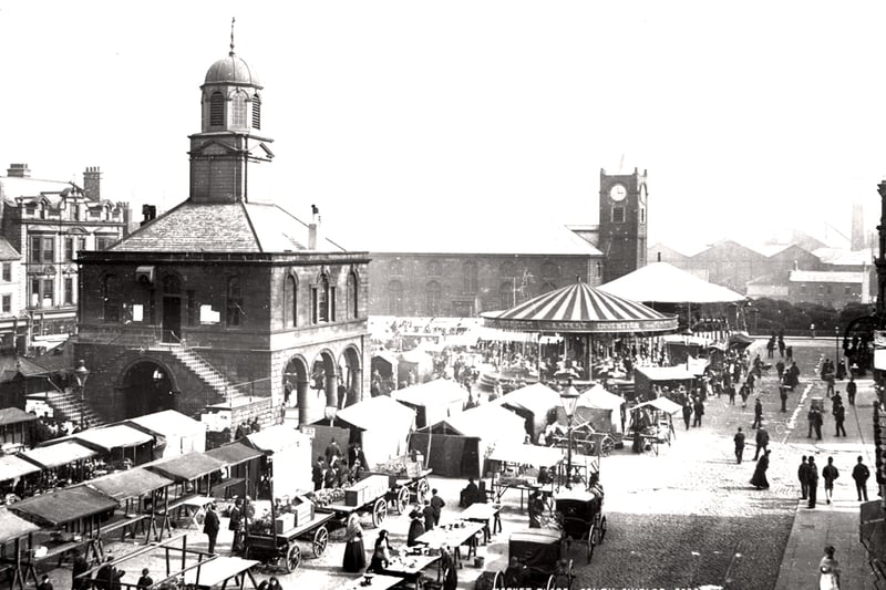 View of South Shields Market taken by Auty in c.1890 showing a busy market day with stalls people horse-drawn carriages and a small fairground. (Newcastle Libraries)