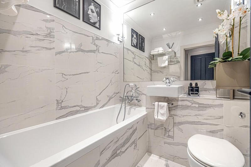 The luxurious re-fitted bathroom also features “Carrera” style tiles and has a bath. 