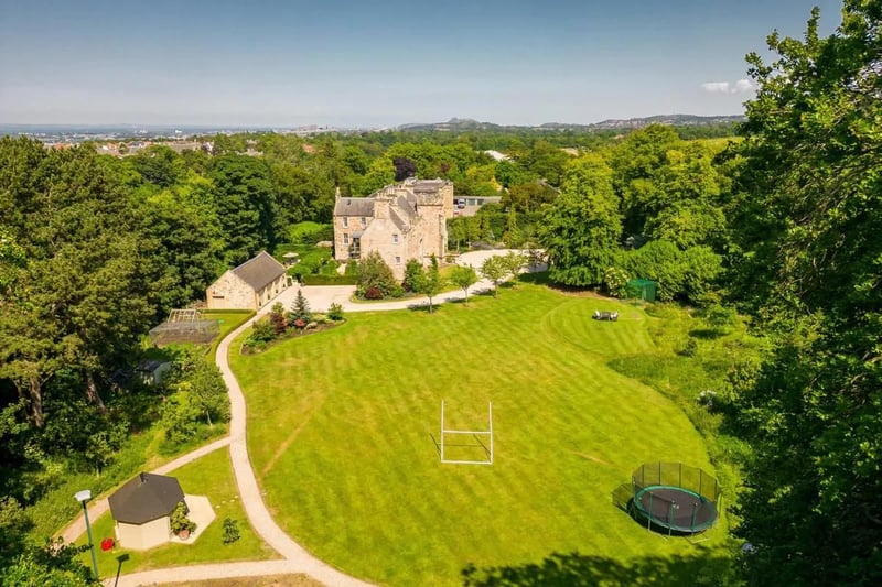 The house sits within 7.8 acres of landscaped gardens and woodland.