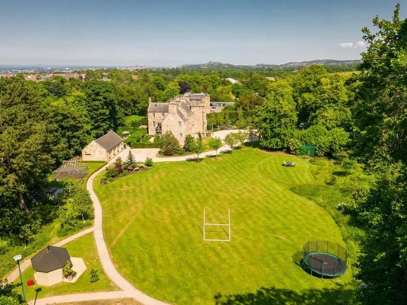 The house sits within 7.8 acres of landscaped gardens and woodland.