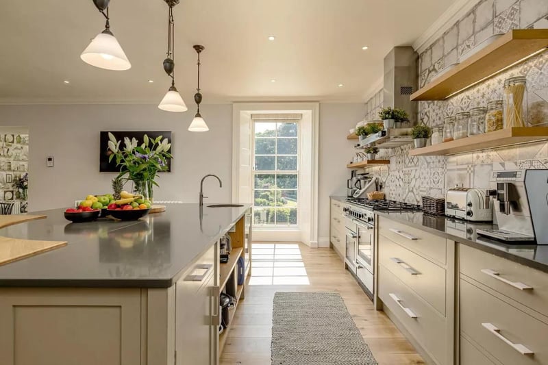 The bespoke kitchen has been designed and handmade by Michael Hart, is fitted with a large central island and comes complete with top-of-the-range appliances.
