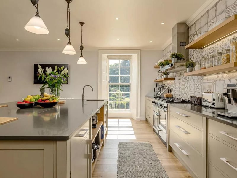 The bespoke kitchen has been designed and handmade by Michael Hart, is fitted with a large central island and comes complete with top-of-the-range appliances.