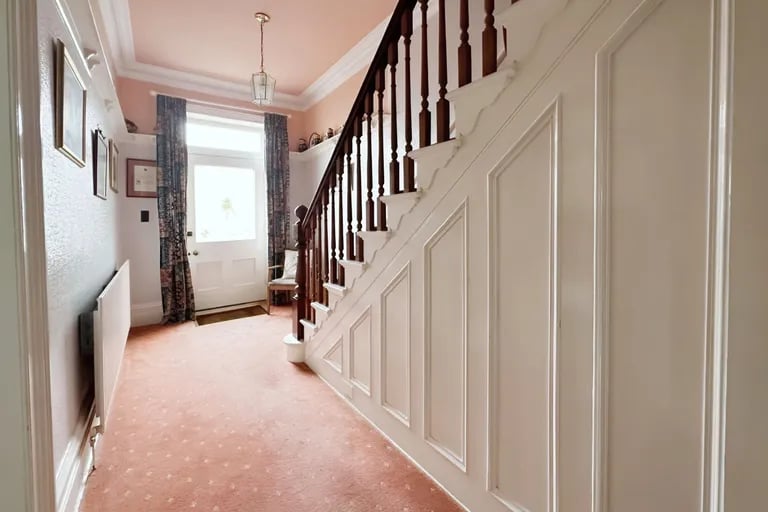 Enter into this large bright hallway with stairs to the first floor.