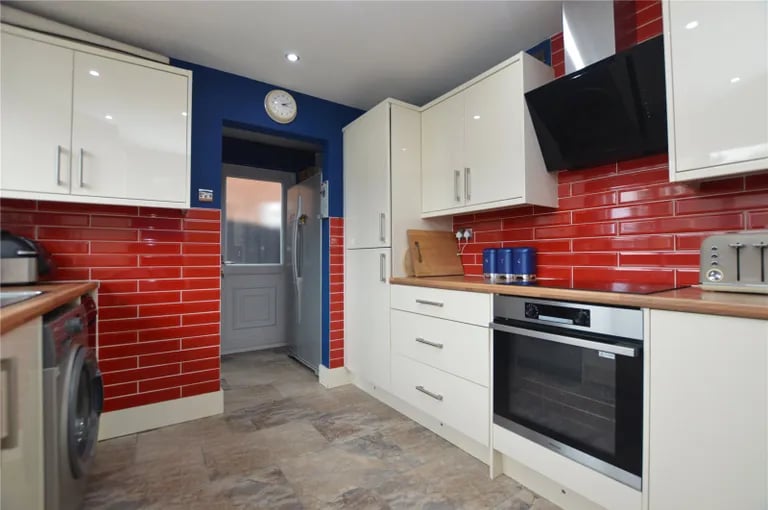 The modern kitchen fitted with high gloss units.