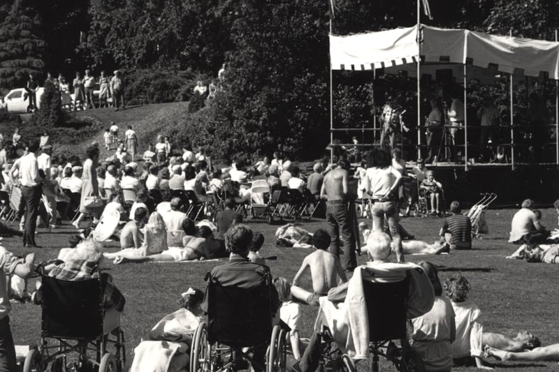 : A view of Jesmond Dene Newcastle upon Tyne taken in 1984. The photograph shows a crowd watching a band playing on a temporary stage.Jesmond Dene was donated to the city by Lord Armstrong in 1883 (Newcastle Libraries)
