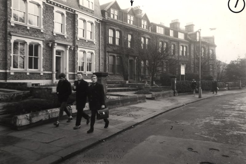 A view of Windsor Crescent Jesmond taken in 1963. The photograph shows the three-storey houses on the left-hand side of Windsor Crescent. In the foreground three young men are walking past the houses (Newcastle Libraries)