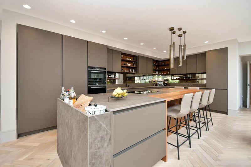 The kitchen has been described as the "heart of the home". It features an induction hob with a worktop extractor, an instant hot water tap, and a Gaggenau fridge.