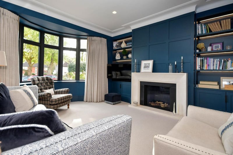 This living area has a front facing bay window and a feature temperature-controlled living flame gas fire.
