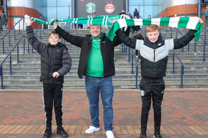 Three Hibs show off their green and white scarves as they arrive at Scotland's national stadium. 
