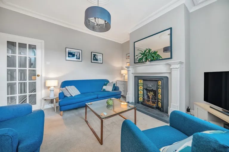 It has high ceilings, a feature fireplace and south-east facing windows overlooking the rear garden.