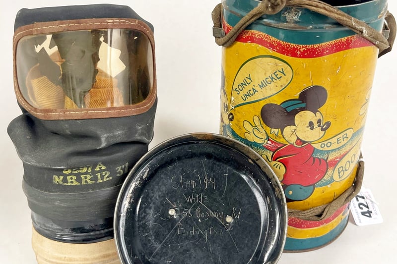 WW2 Mickey Mouse tinplate gas mask case (RichardWintertonAuctioneers/SWNS)