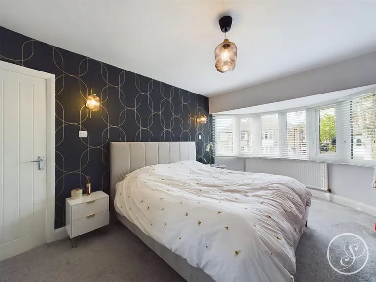 The master bedroom sits to the front and has a large bay window.