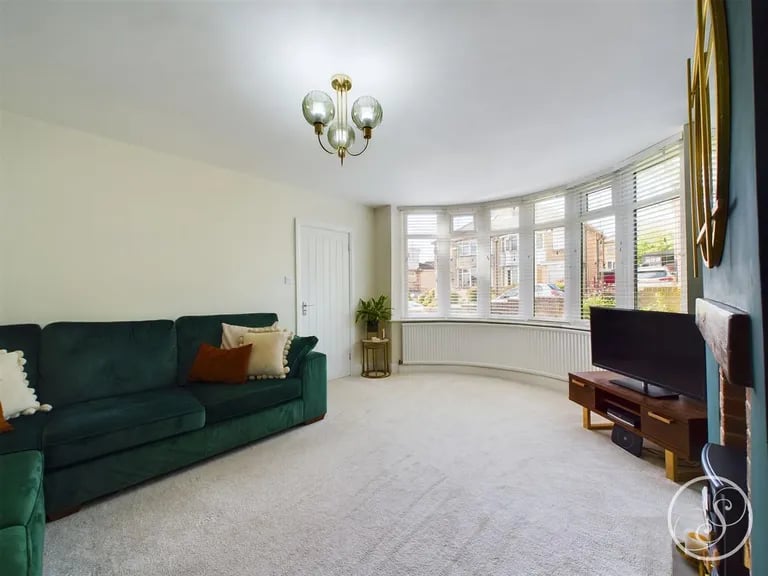 It gets flooded in natural light from this bay window to the front elevation.