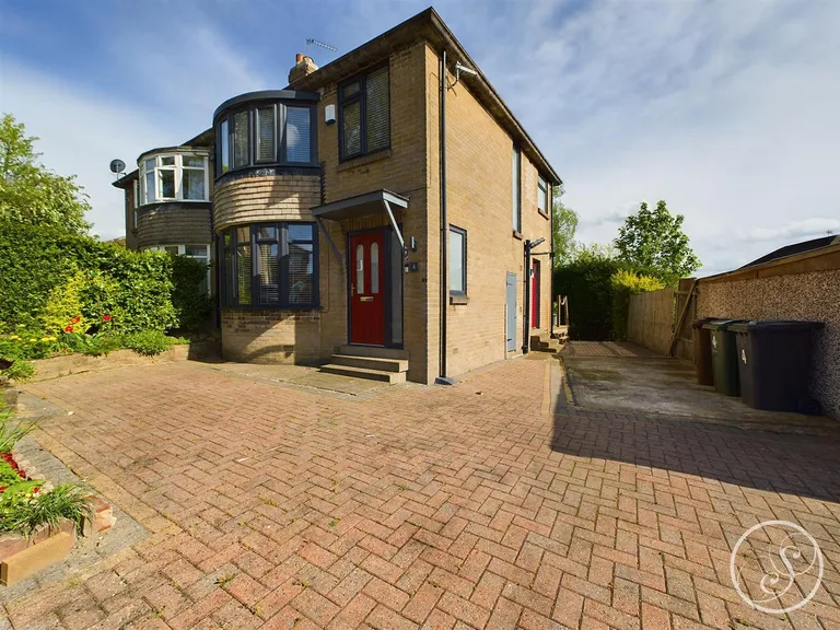 To the front of this Meanwood property is a large driveway.