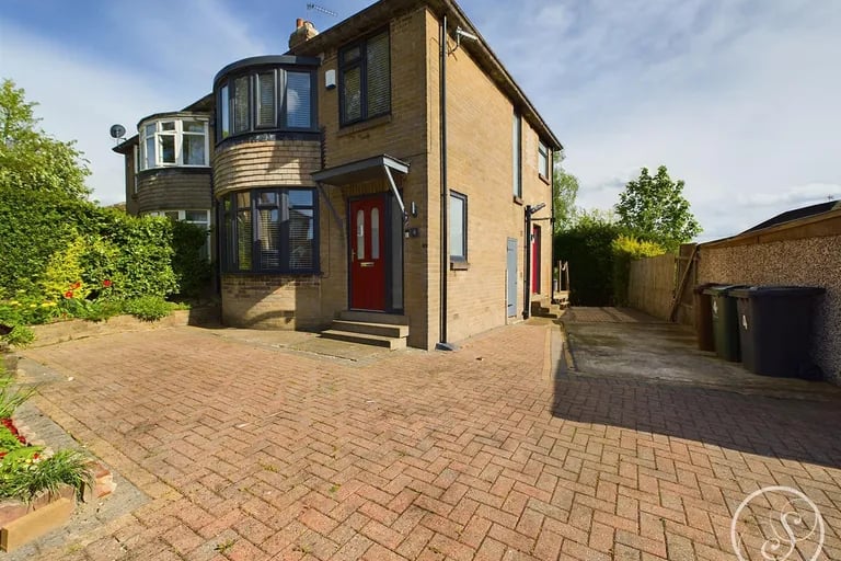 To the front of this Meanwood property is a large driveway.