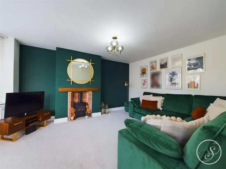 The lounge is a large and colourful room with feature fireplace.