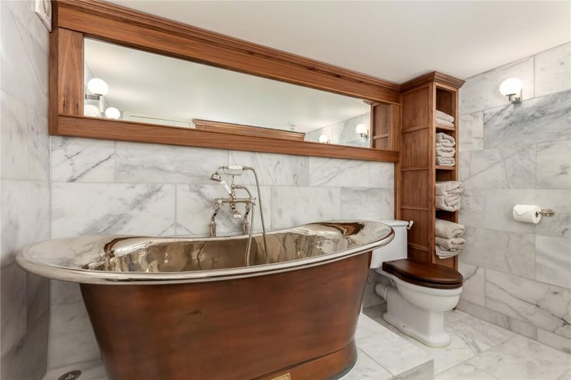 The bathroom hosts a free-standing bathtub