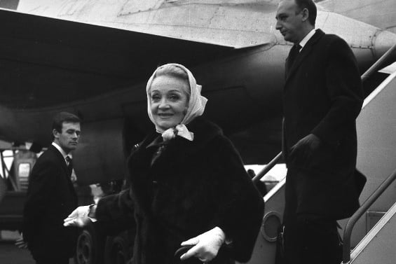 Marlene Dietrich getting off a plane before heading to her suite at the Roker Hotel in 1966.