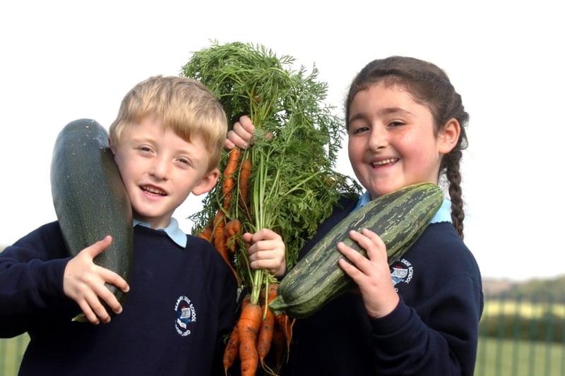 Leon Fryatt and Layla Amir looked proud of the bumper crop of vegetables grown in the school vegetable garden in 2010.