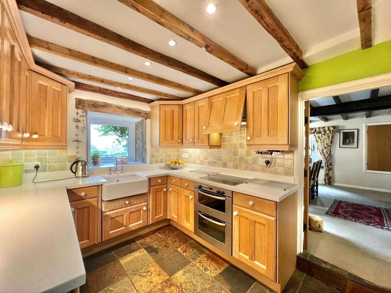 The exposed beams in the kitchen are part of the property's history. (Photo courtesy of Zoopla)