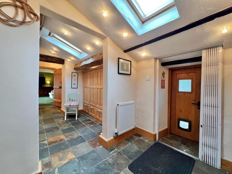 The front door opens into this space which comprises of a hallway, utility room and another hallway. (Photo courtesy of Zoopla)