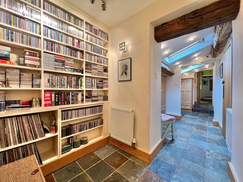 This hallway provides excellent storage space for someone with a big book or DVD collection. (Photo courtesy of Zoopla)