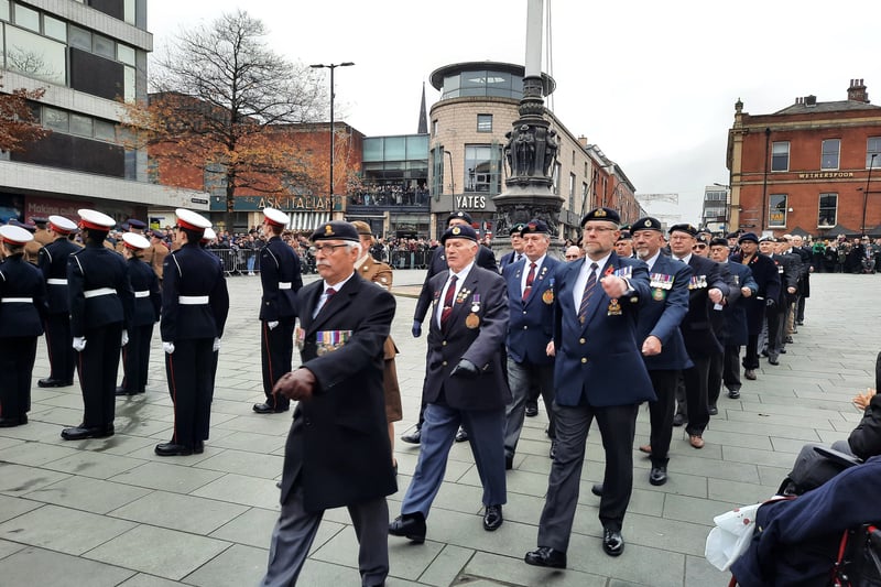 Veterans march past the war memorial at the end of the service to grateful applause from the crowd.