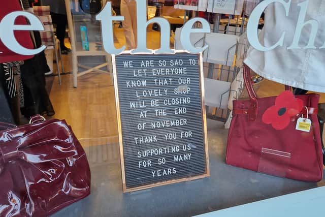 A sign at the Save the Children shop announces impeneding closure.
