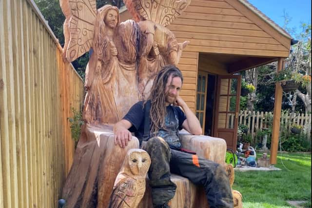 Alex with Once Upon a Time, a ‘storytelling throne’, carved from a single cedar stump which includes an owl, a hedgehog and fairies. 
