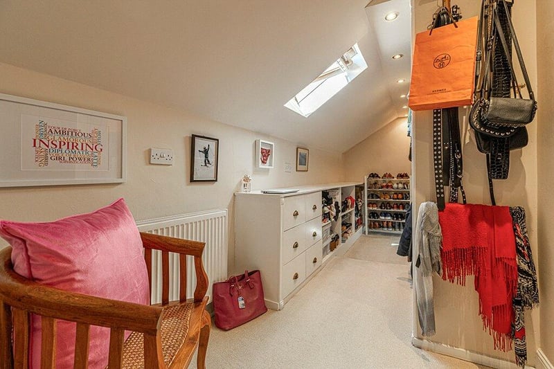 The fitted dressing room is found on the second floor with a velux window and built-in storage. 