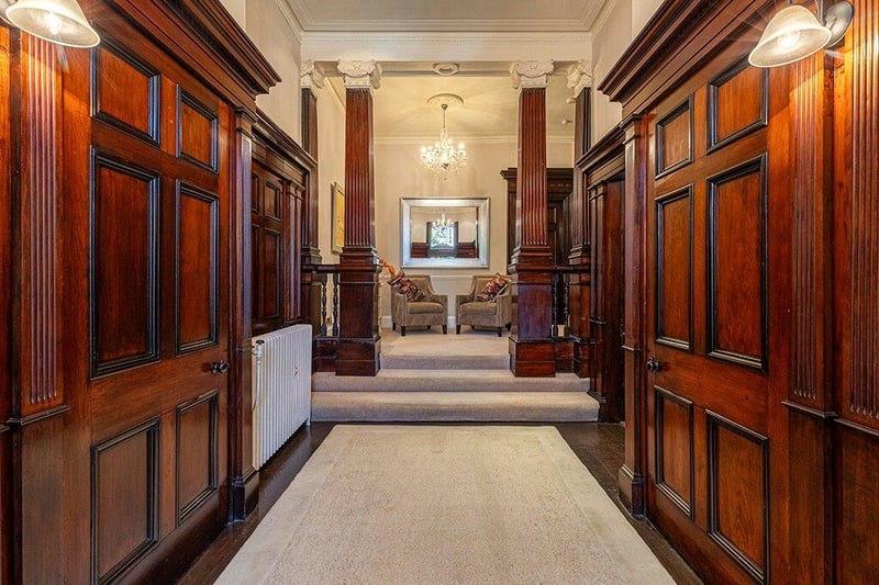 A look inside the wonderful reception hallway which is split level. The lower section has original woodwork and three storage cupboards.