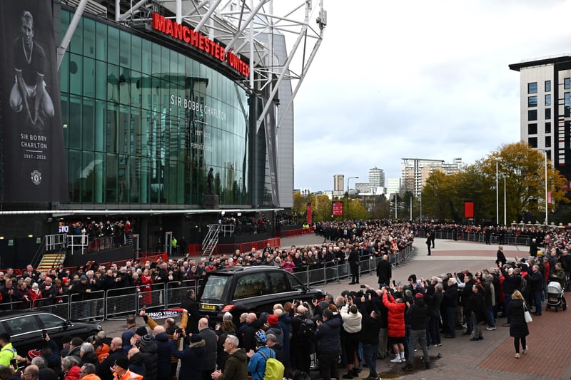 The funeral procession goes past Old Trafford