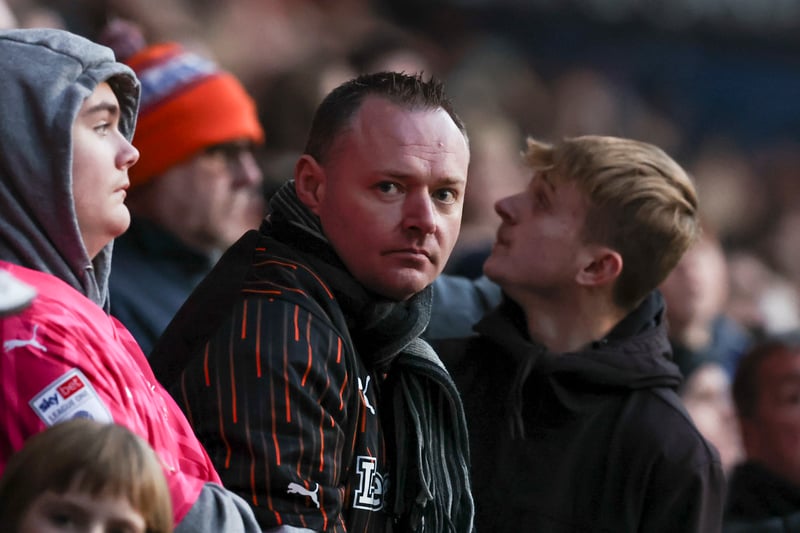 A Blackpool fan stares down at the lens of the camera. 