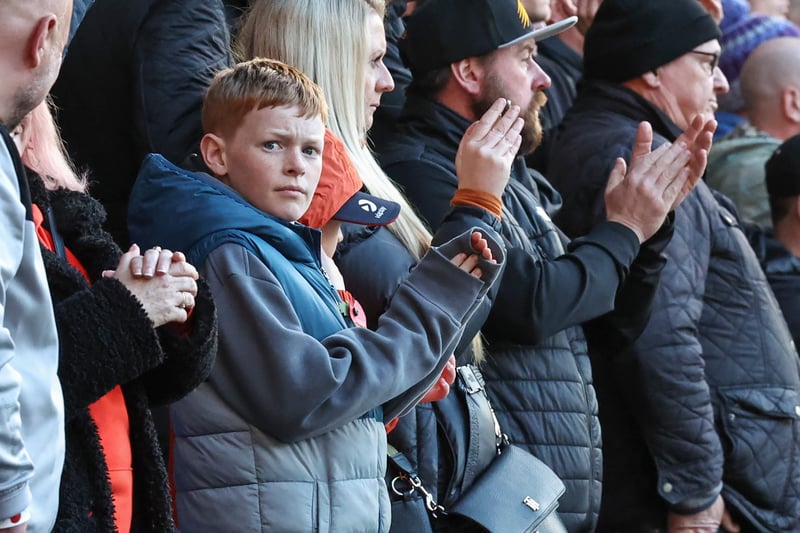 Blackpool fans applaud their team at the end of the minutes silence on Remembrance Day