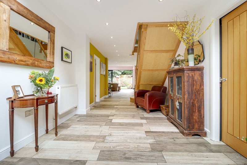 Step inside a spacious, bright yet welcoming hallway with immediate views of rear landscaped and well manicured gardens where cleverly the outside feels part of the home.