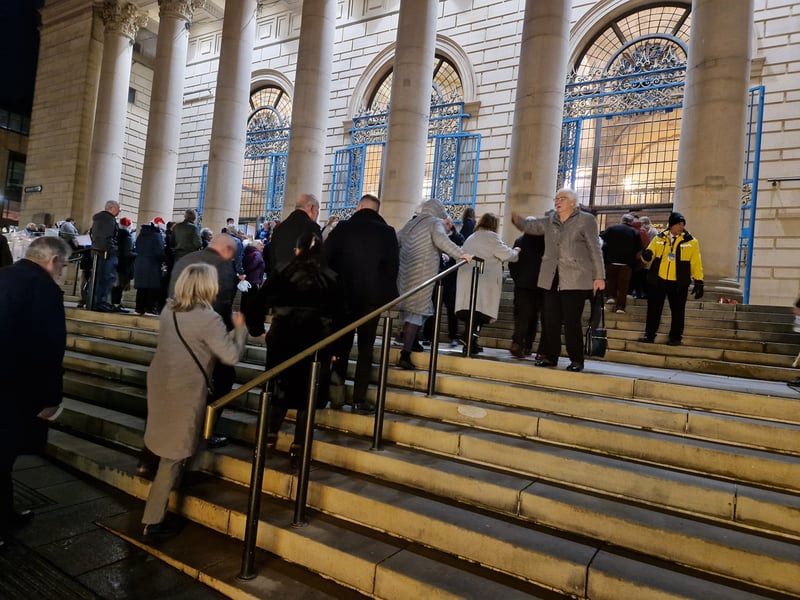 Sheffield was packed as thousands headed for the city centre for the recording of the Christmas Songs of Praise. Crowds walk up the City Hall steps. Picture: David Kessen, National World