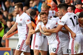 Billy Sharp of Sheffield United celebrates with teammates after scoring his team's first goal  during the Premier League match between AFC Bournemouth and Sheffield United at Vitality Stadium on August 10, 2019 in Bournemouth, United Kingdom. (Photo by Michael Steele/Getty Images)