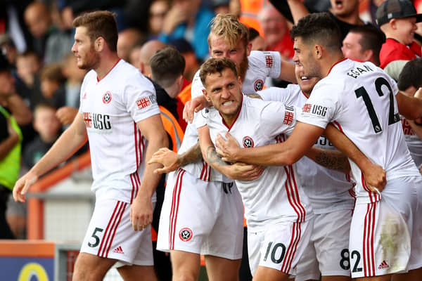 Billy Sharp of Sheffield United celebrates with teammates after scoring his team's first goal  during the Premier League match between AFC Bournemouth and Sheffield United at Vitality Stadium on August 10, 2019 in Bournemouth, United Kingdom. (Photo by Michael Steele/Getty Images)