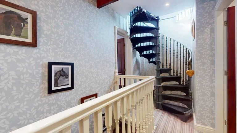 On the first floor landing is a spiral stair case to the loft room.