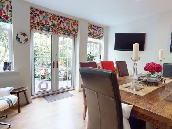 The spacious dining area has double French doors to the rear garden.