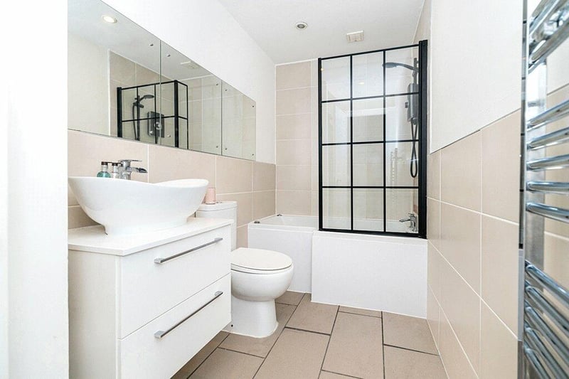 Three-piece bathroom comprising twelve jet jacuzzi bath, over bath shower, toilet and wash hand basin.