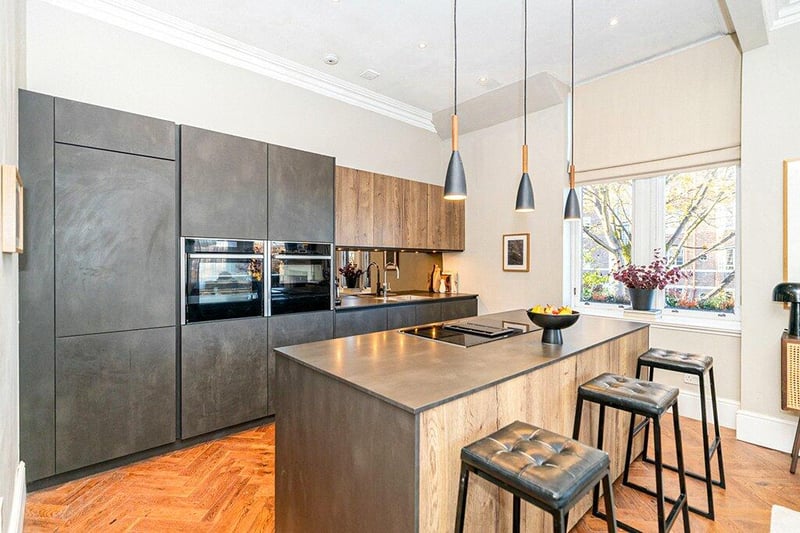 The stunning re-fitted kitchen by Gideon Robinson complete with a range of base and wall units, high quality integrated appliances including NEFF slide and hide sous vide oven, Siemans induction air venting hob, wine cooler, Quooker tap, intergrate NEFF dishwasher, integrated washing machine. 